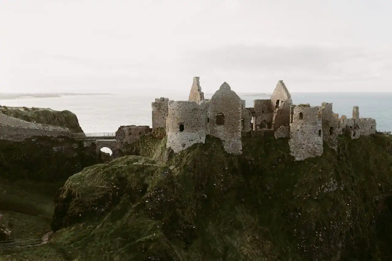 Explore the captivating ruins of Dunluce Castle overlooking the sea in Northern Ireland.