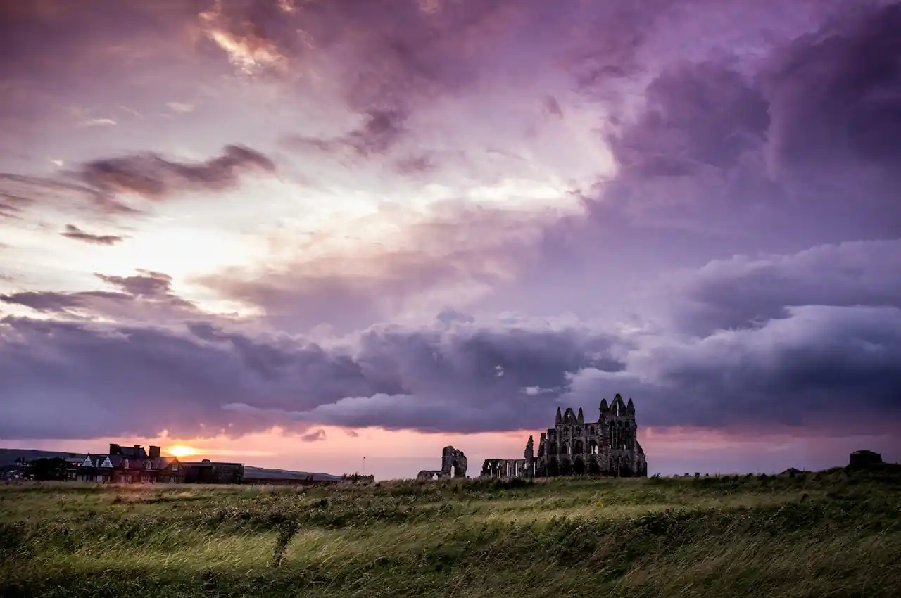 Explore stunning rural landscapes with a majestic castle ruin illuminated by a purple sunset sky.